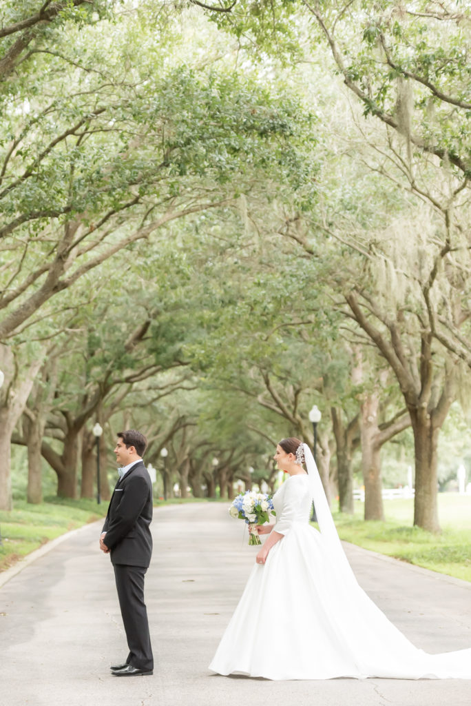 bride walking up to groom for a first look at cypress grove estate house 